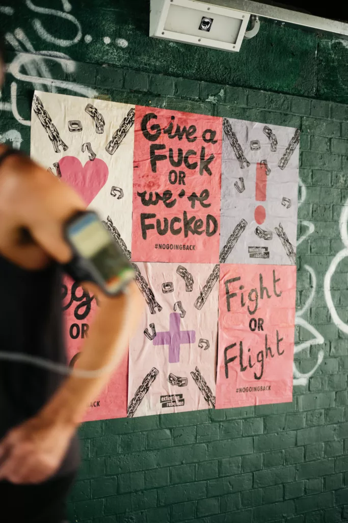 An urban artist captures a social message on a vibrant street art poster.