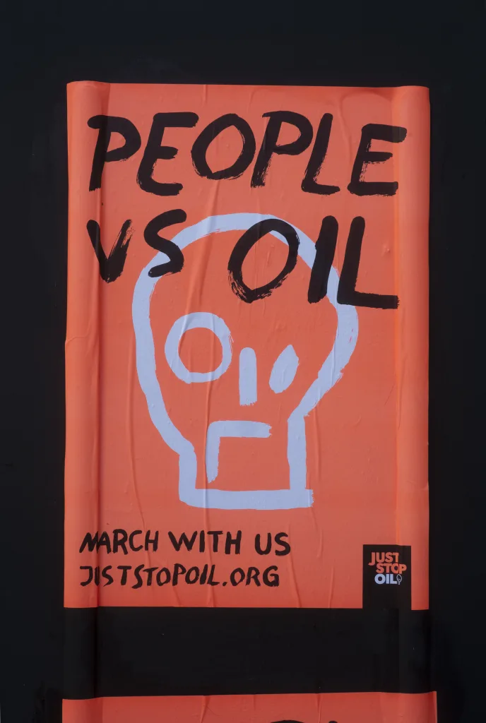 Protest poster with the slogan "people vs oil" calling for a march, symbolising the conflict between human interests and fossil fuel consumption.