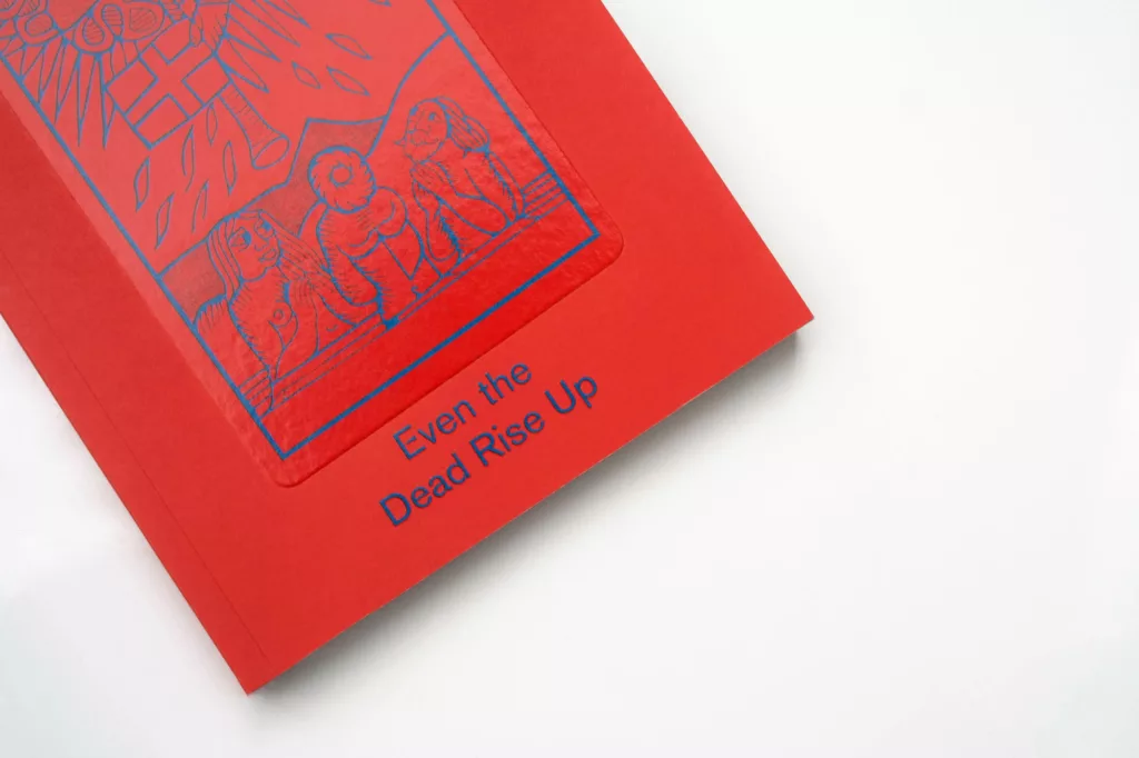A red book cover with embossed illustrations and the title "even the dead rise up" on a plain white background.