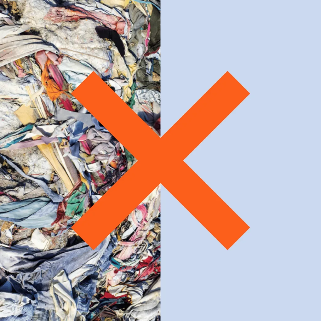 The image shows a close-up view of a large pile of mixed textiles and garments, seemingly discarded or ready for recycling, with a bold orange "x" overlaid, which might indicate rejection, cancellation, or a problem associated with the contents of the image.