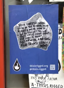 A torn protest poster on a wall with a qr code and the slogans "your liberties, your rights were won by suffragettes, by the once rad. fight for what is right now. no new oil and gas. fair transition now." and the website "thisisrigged.org".