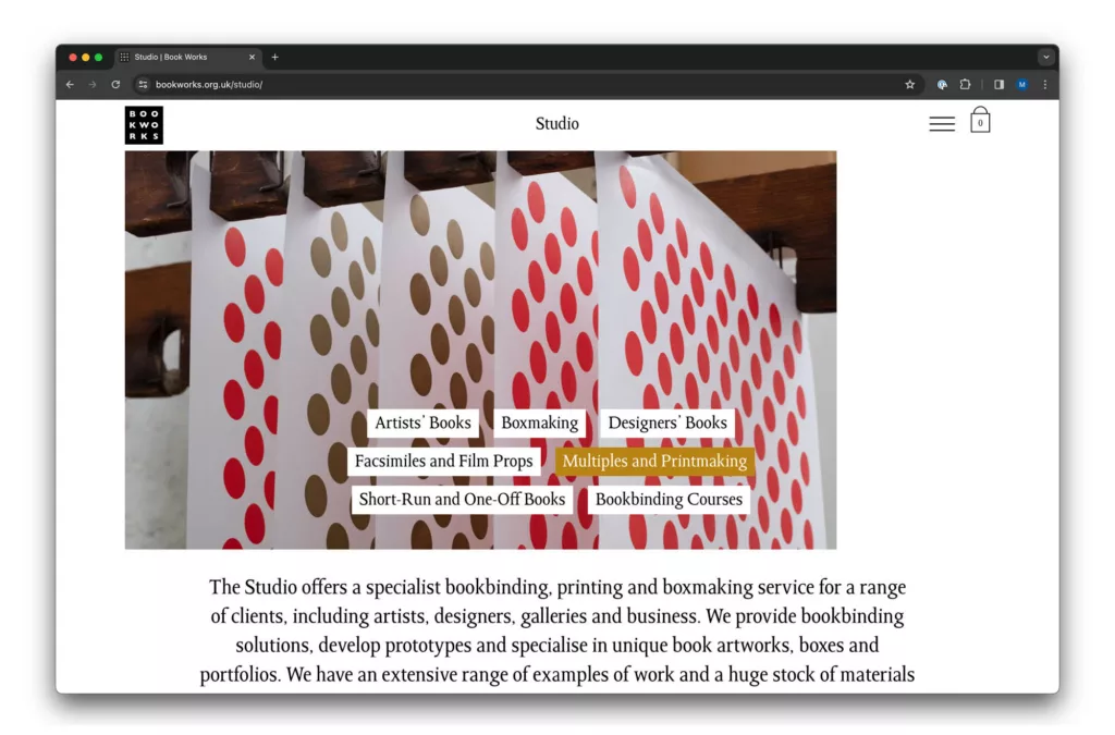 A web browser displaying a website for a studio that offers specialized bookbinding and boxmaking services, shown through an artsy background with colorful circle patterns.