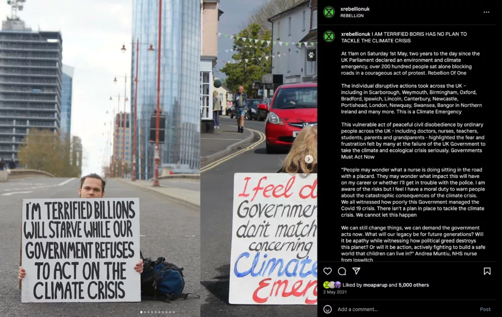 The image displays a protest sign with the message "i'm terrified billions will starve while our government refuses to act on the climate crisis" against an urban backdrop, signaling a call to action on climate change and the urgency felt by the protester.